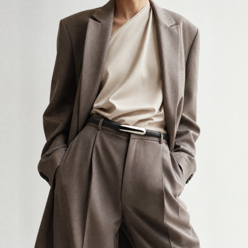 Generated with Kive.ai - need photo to sell those belts_ frame from the neck to the tighs. minimalist outfit in earth colours_ but no green_ made of luxury fabrics like wool silk_ outfits more for spring summer than autumn winter. white (3).png