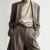 Generated with Kive.ai - need photo to sell those belts_ frame from the neck to the tighs. minimalist outfit in earth colours_ but no green_ made of luxury fabrics like wool silk_ outfits more for spring summer than autumn winter. white (3).png