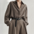 Generated with Kive.ai - need photo to sell those belts_ frame from the neck to the tighs. minimalist outfit in earth colours_ but no green_ made of luxury fabrics like wool silk_ outfits more for spring summer than autumn winter. whit (14).png