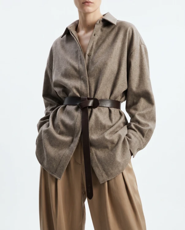 Generated with Kive.ai - i need photo to sell those belts_ frame from the neck to the tighs. minimalist outfit in earth colours_ but no green_ made of luxury fabrics like wool silk_ outfits more for spring summer than autumn winter. whi (4).png