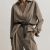 Generated with Kive.ai - need photo to sell those belts_ frame from the neck to the tighs. minimalist outfit in earth colours_ but no green_ made of luxury fabrics like wool silk_ outfits more for spring summer than autumn winter. whit (15).png