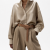 Generated with Kive.ai - need photo to sell those belts_ frame from the neck to the tighs. minimalist outfit in earth colours_ but no green_ made of luxury fabrics like wool silk_ outfits more for spring summer than autumn winter. whit (19).png